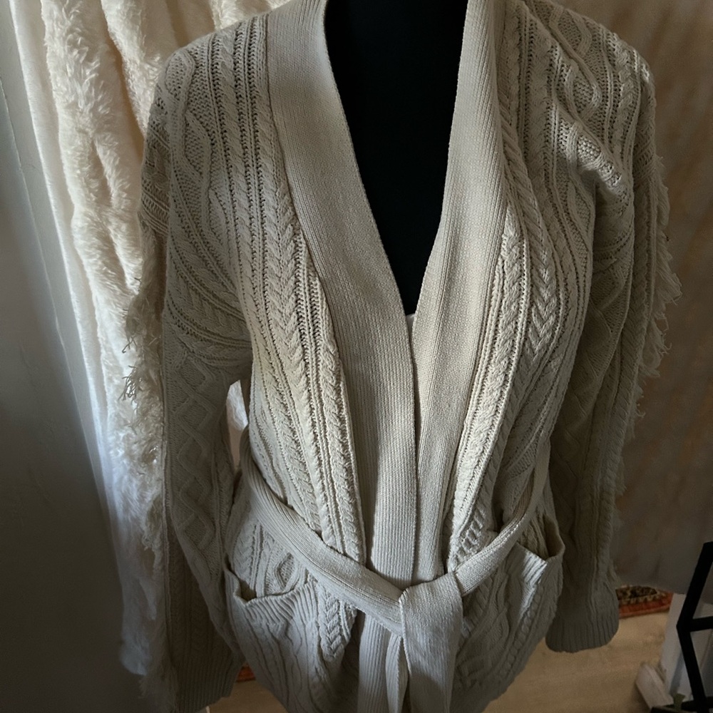 A little frilly up the sleeves creamy sweater size M